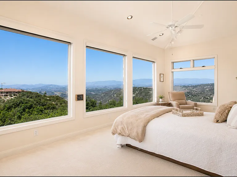 Relax in your primary suite and savor incredible panoramic views spanning from the mountains to the ocean, offering a vantage point that rivals the view from an airplane at over 1,000 feet in the air.