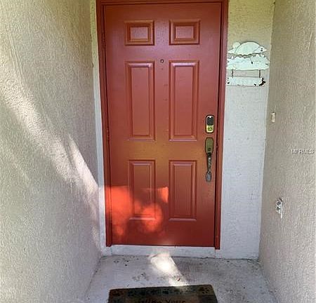 Covered entrance lanai showing door with security lock