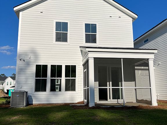 Back of house including screened porch. Backyard patio with fire pit is currently under construction and not pictured