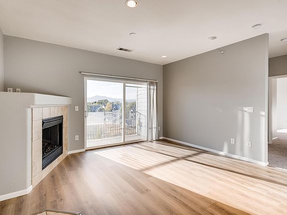 Living room with mountain views and fireplace.
