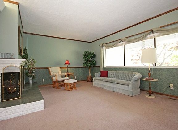 Large living room with lots of window to view your cottage garde