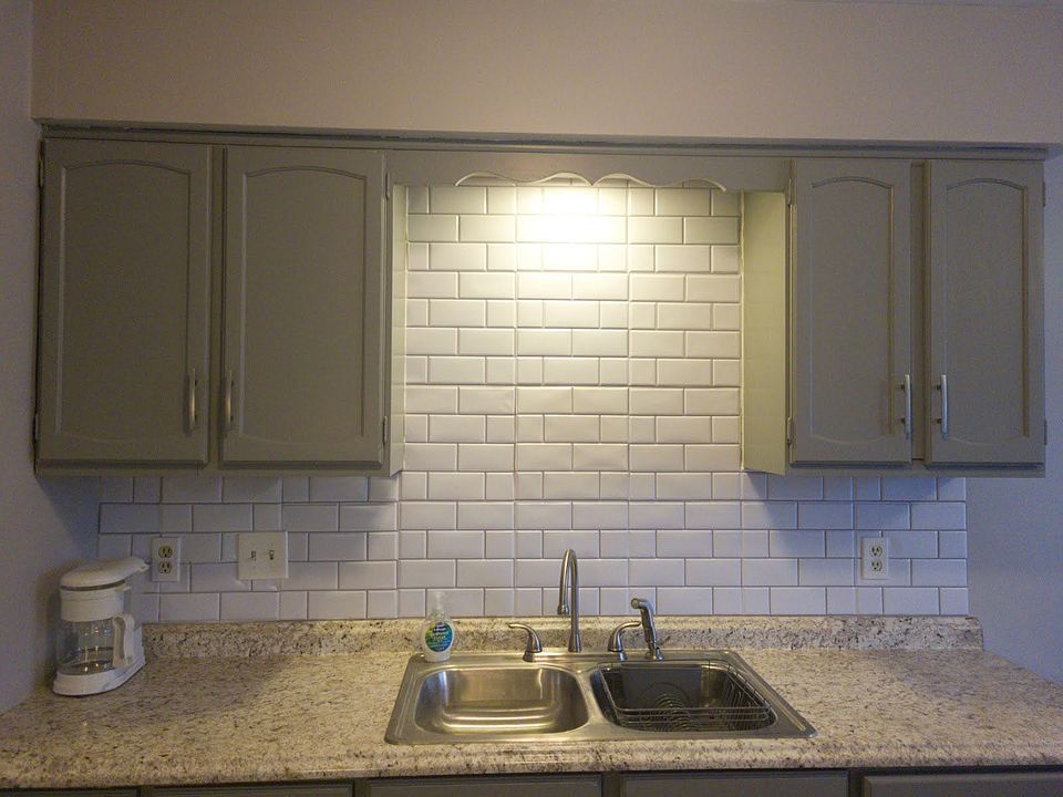 well lit sink area with freshly painted cabinets