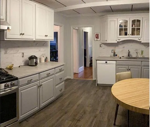 Kitchen with brand new stove, sink, dishwasher, disposal. Walk-in pantry area.