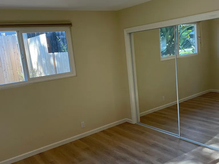 Mirrored closet doors in main bedroom