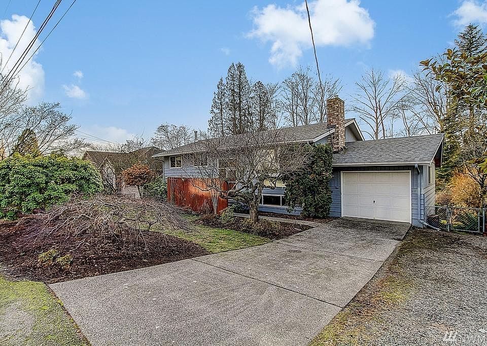 View of the home with large driveway
