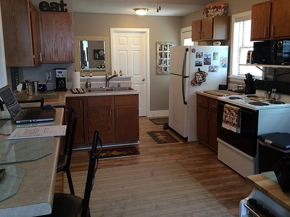 Huge eat-in kitchen with four barstools.