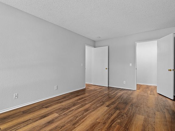 Spacious bedrooms with wood plank flooring