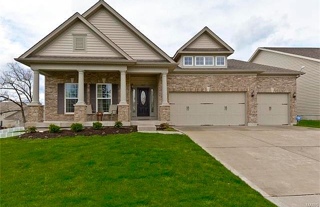 Upgrade elevation with full brick and column with common ground on left side of home when looking at