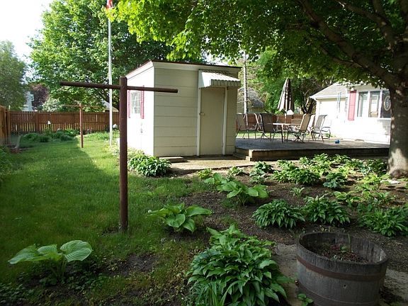 side of yard showing hosta garden and potting shed/deck