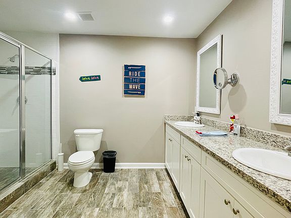 Primary bath with dual sinks and granite countertops.