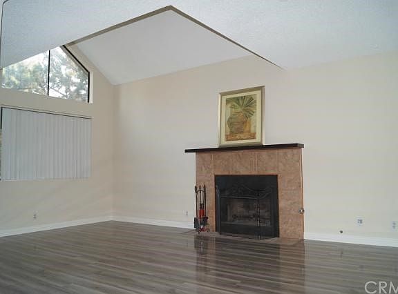 Living Room with fireplace and high ceiling