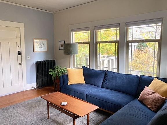 Front door into living room with common deck in the background.