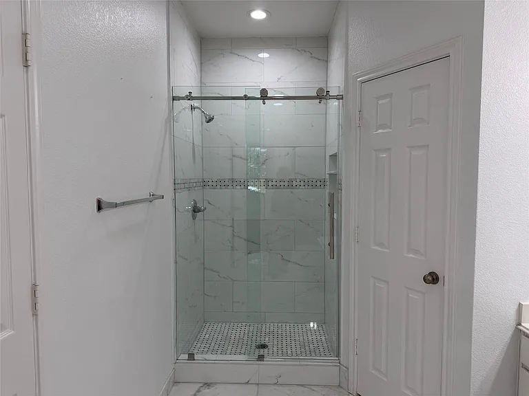 Primary en suite bathroom has been updated with beautiful shower.