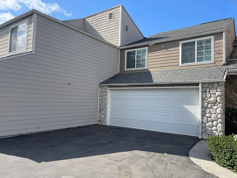 The studio is above the garage where the two windows are.