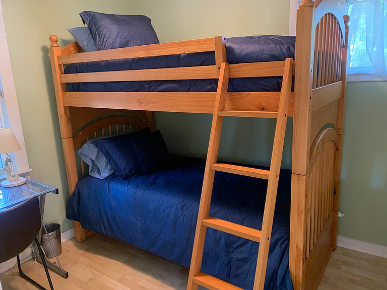 Second bedroom has bunk beds, desk, and full size closet.