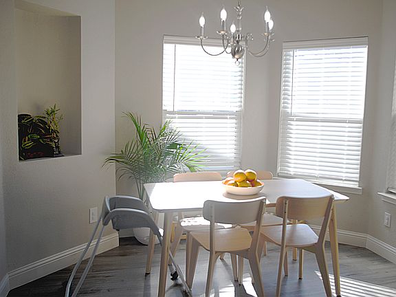 The dining area is flooded with natural light. There is enough space for a table that seats eight to ten people.