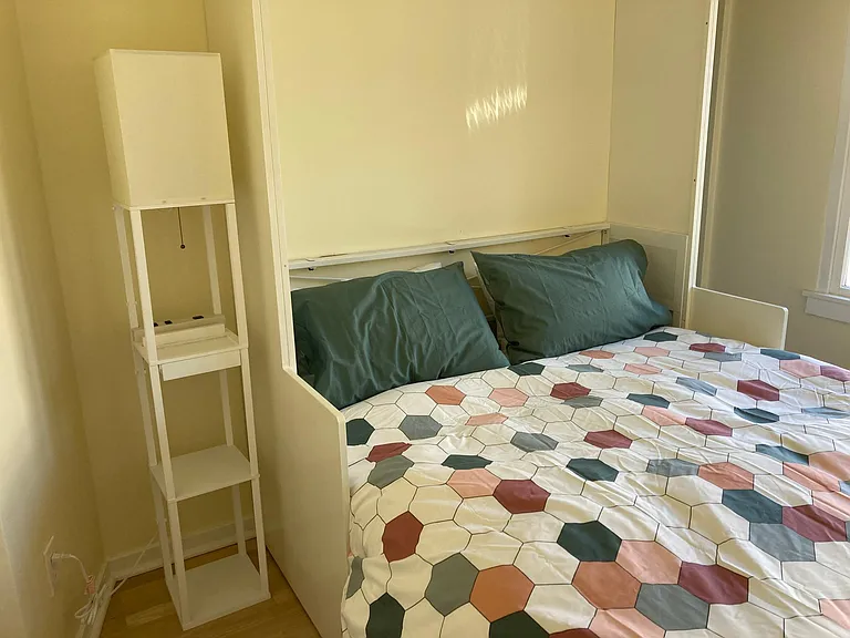 The queen-size murphy bed is a cozy place to sleep.