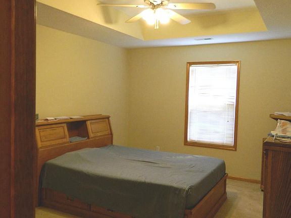 The downstairs master bedroom features a tray ceiling w/fan.