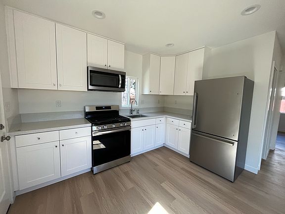 Renovated kitchen with stainless steel appliances and quartz countertops