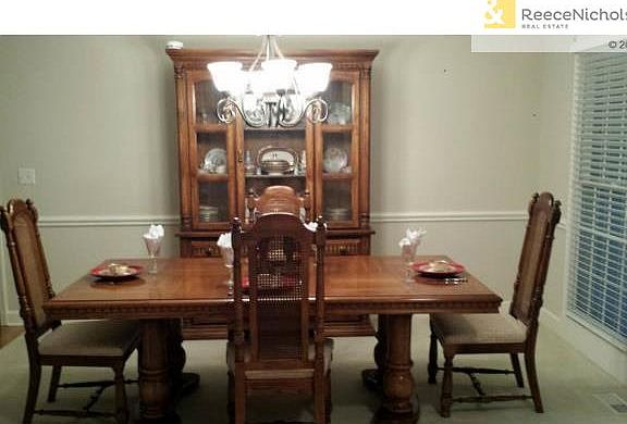 Large formal dining room with wall of windows and updated lighti