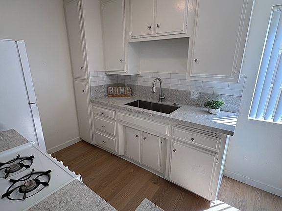 Updated Kitchen with refrigerator, large sink and bartop.