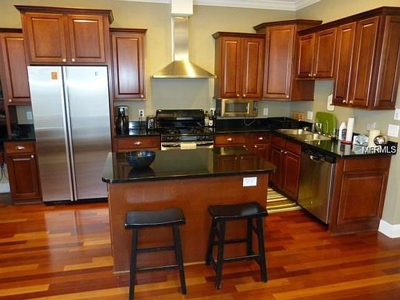 Large center island kitchen with stainless steel appliances. Overlooks family room.  Notice the Brazilian hardwoods that are thr