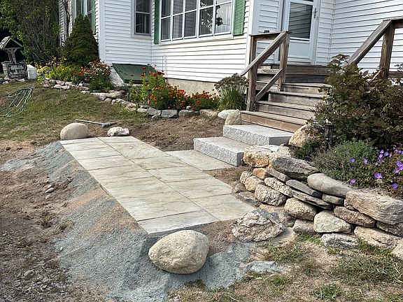 New granite steps leading to your front door and gravel driveway.