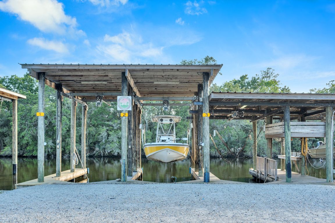 High quality boat house with 3 lifts and a backdown ramp.  You can even fish right off the dock.