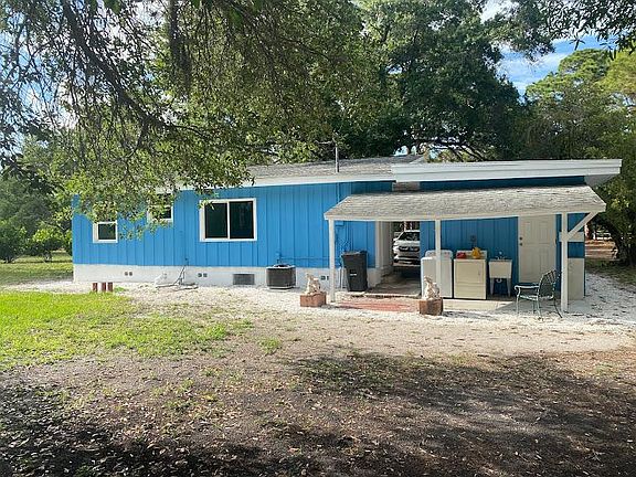 Back of house, faces south, covered out door laundry, new concrete slab, new sink too.