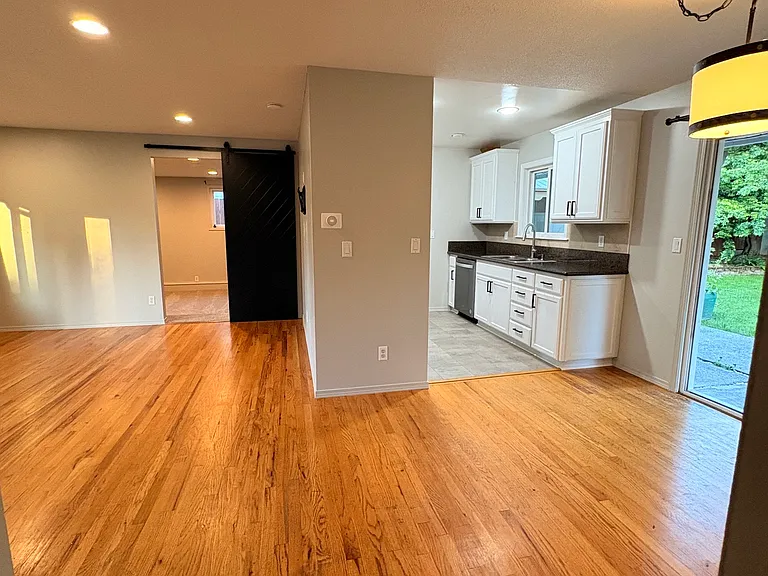 Semi Open concept dining, living room, and kitchen from hall