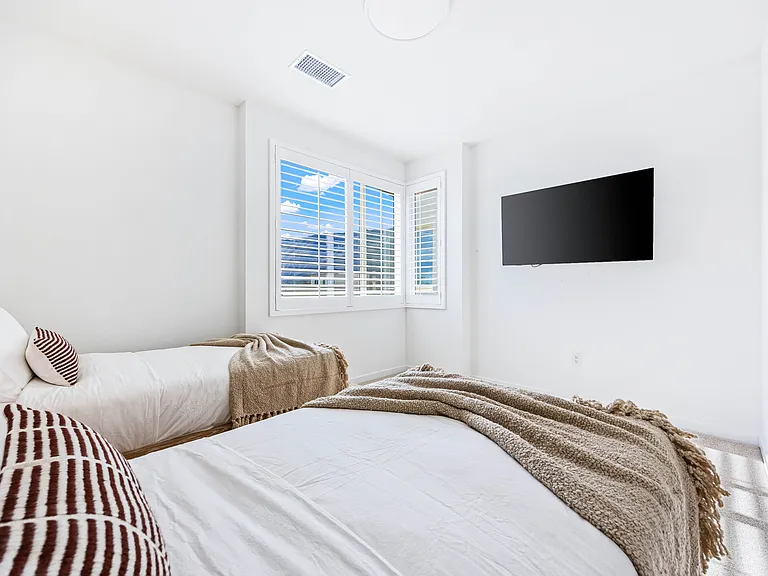 Crisp white linens and natural light in every bedroom here.