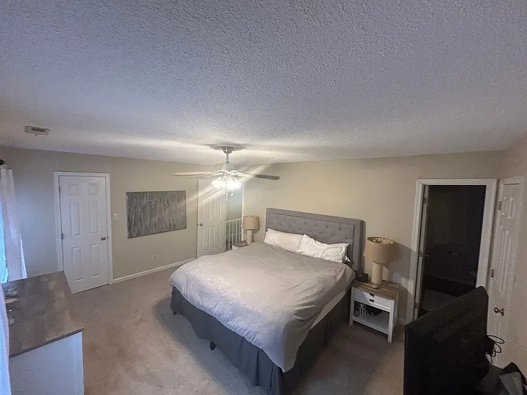 Expansive bedroom with three walk-in closets, abundant storage space, and a beautifully remodeled private en-suite bathroom.