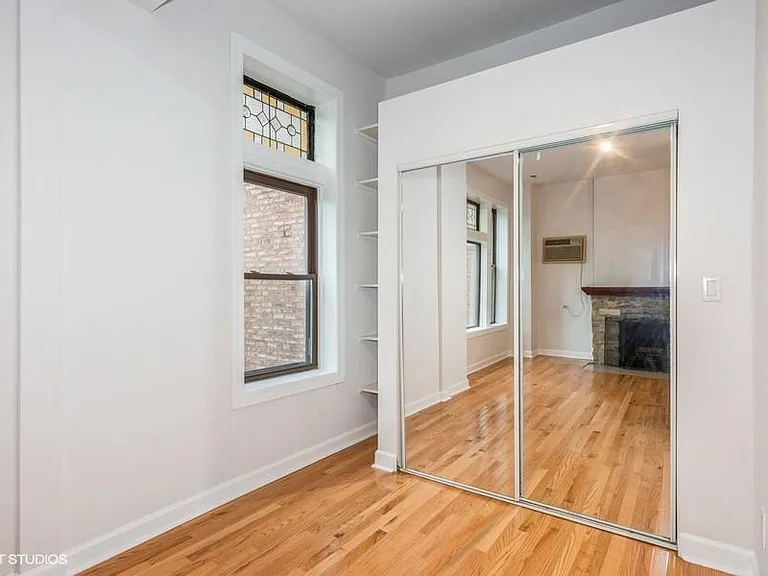 Den area with built in shelves and large mirrored closet