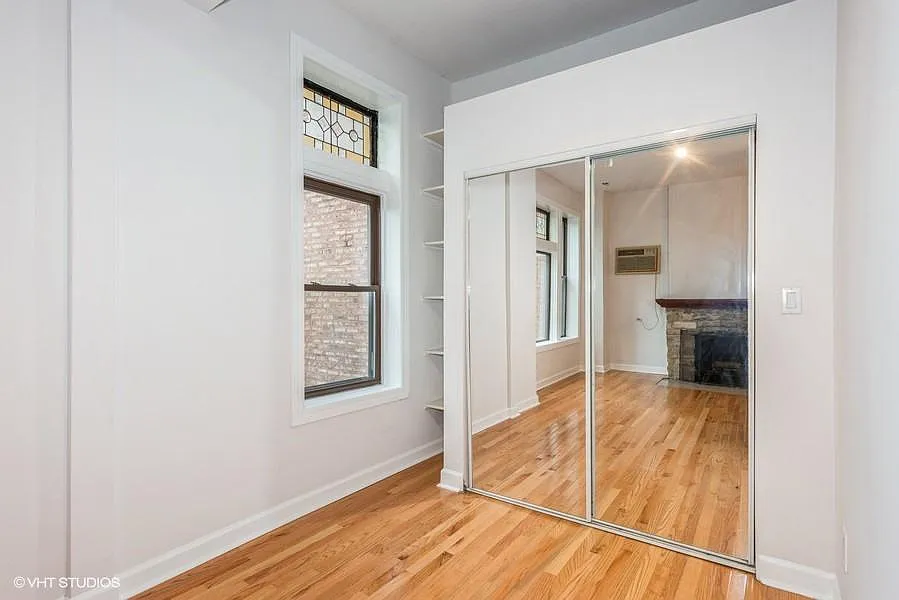 Den area with built in shelves and large mirrored closet