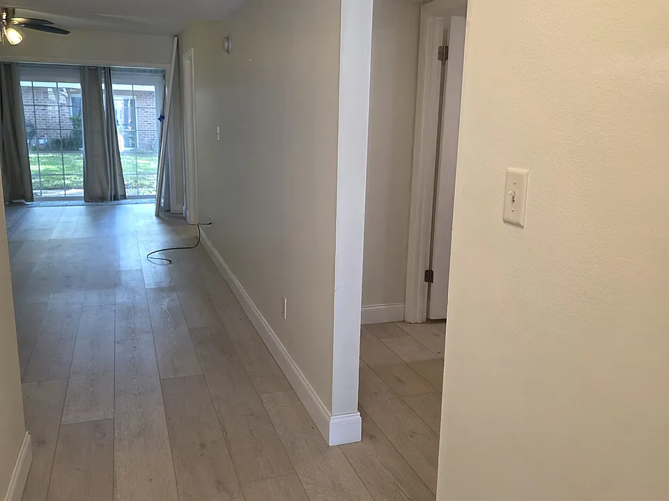 View of the hall to the bathrooms and the second bedroom from the entrance.