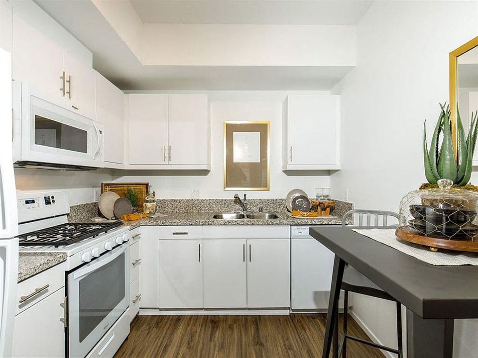 Spacious kitchen white them with stove microwave sink