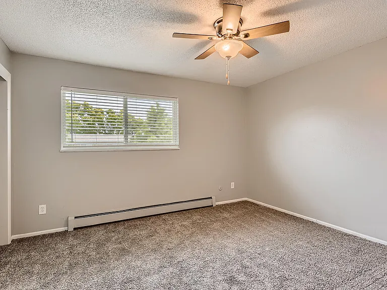 A bedroom with a window and floor heater at Alder Square Rental Townhomes