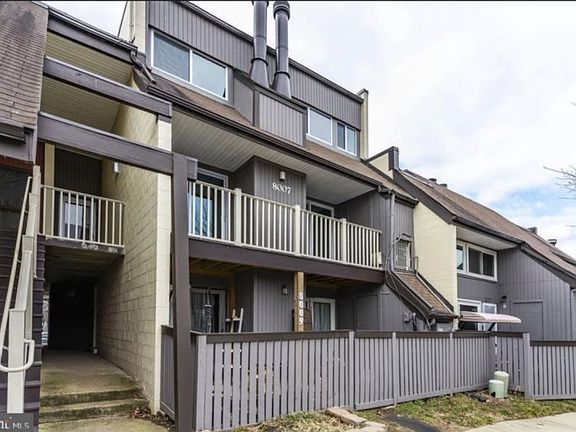 Condo exterior with private outdoor space and easy access to parking and walking paths.