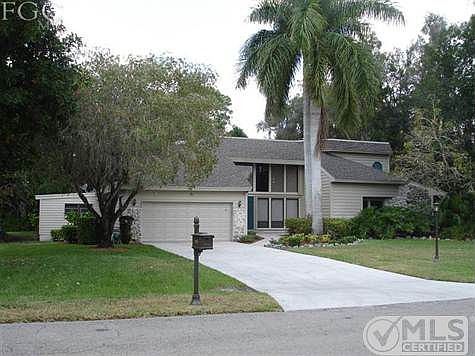 Front view of home. Accordian style shutters on outside of the bank of windows for protection.