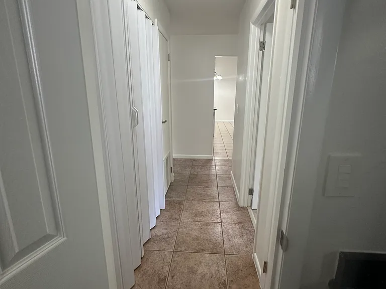 View from hall bathroom of bedroom 2 access corridor.