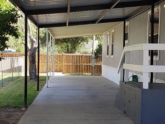 Wooden fencing in the back of the property offers privacy from city park. Citrus and small trees offer shade in the evening on the west side of the property.