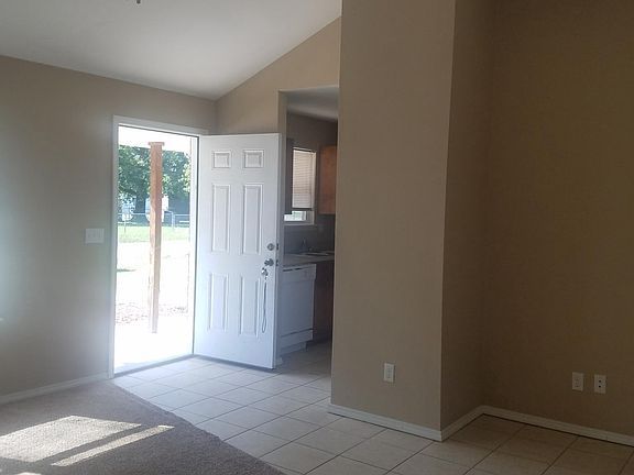 Living room looking out front door and into kitchen.