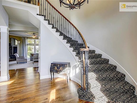 Views through to the living room and gorgeous curved staircase leading second level.