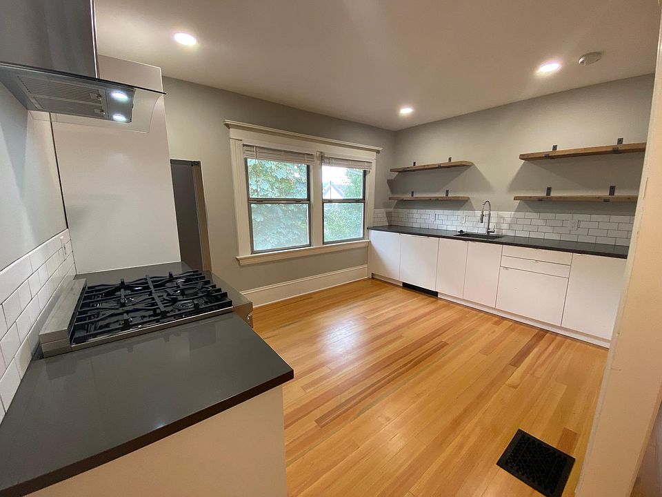 Kitchen with gas burning range, dishwasher, and a lot of storage.