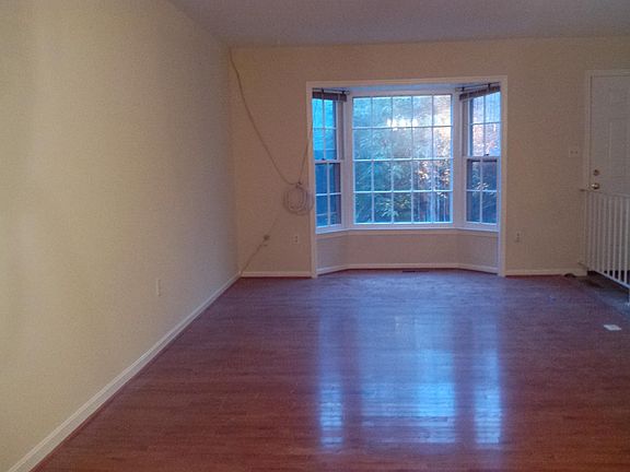 Living room with hardwood floors and bay window