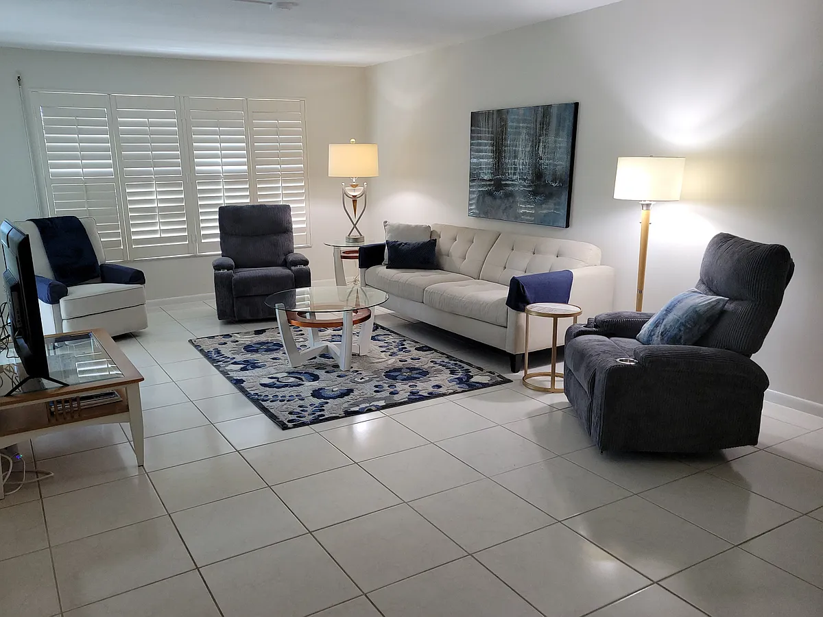 3 recliner & a 65" TV in the living room. - 4200 Belair Ln