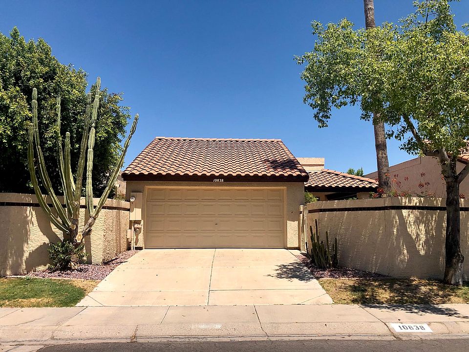 Two-car garage and walled yard with patio