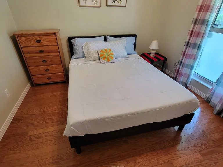 Bedroom 3 with queen size bed, night stand, closet and a chest of drawers.