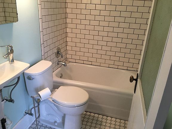 entire bathroom rehabbed with white subway tile surround