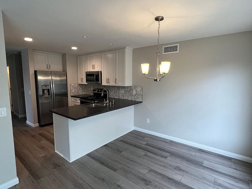 Functional kitchen with adjoining dining area and space for counter seating.